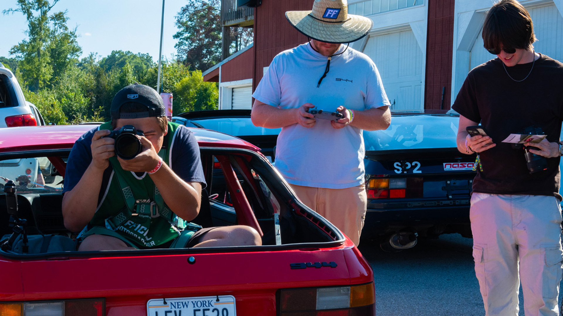 Photographer shooting out the back of a lead car during the track photo session