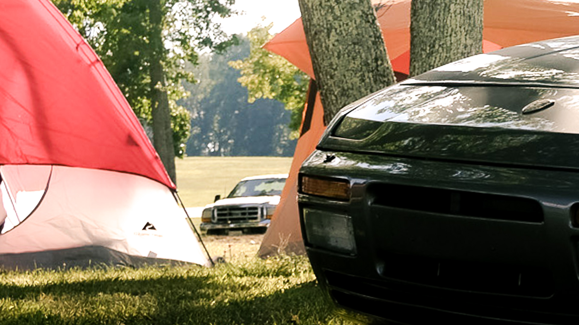 Tent pitched beside a 944 in the paddock at VIR